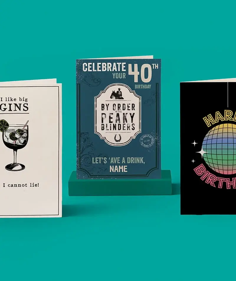 Three birthday cards displayed against a blue background, featuring a gin-themed design, a Peaky Blinders style 40th birthday card and a colourful disco ball birthday card.